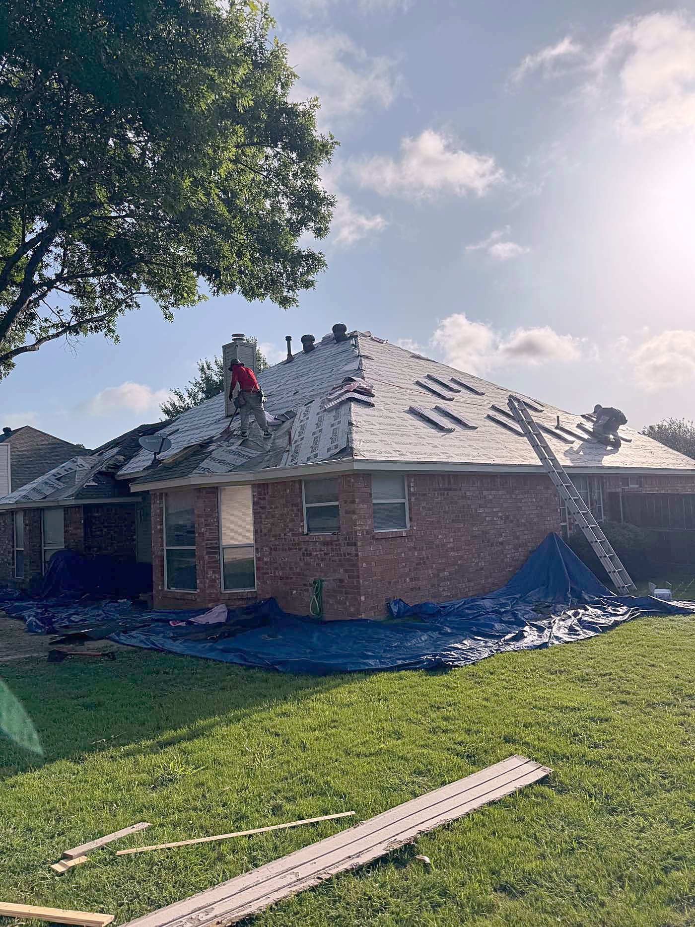 Brick home mid tear-off, seen from the front yard
